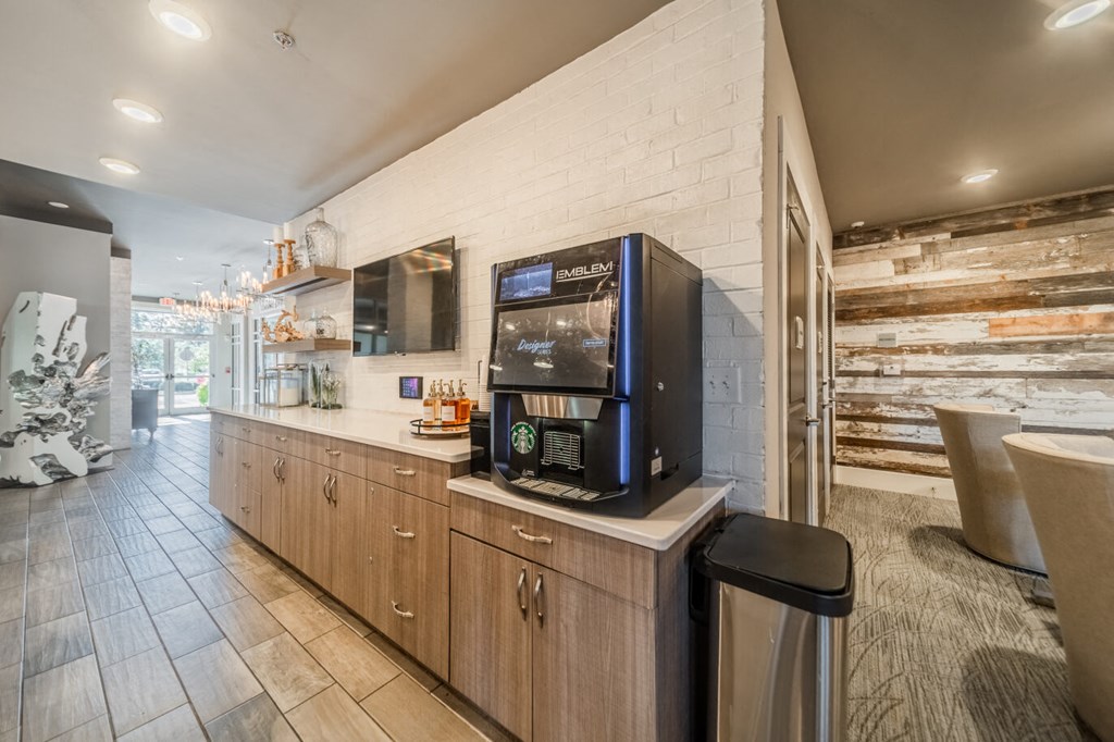 the lobby of a restaurant with a coffee machine on the counter