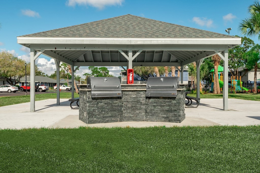 a stone outdoor grill with a pavilion
