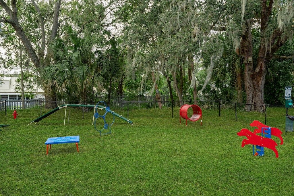 a playground with a seesaw and other toys in a park