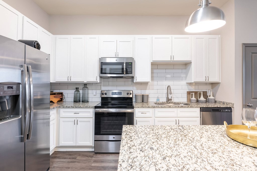 a kitchen with stainless steel appliances and granite counter tops
