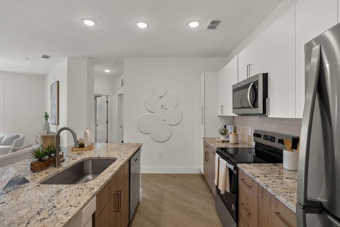 a kitchen with granite counter tops and stainless steel appliances