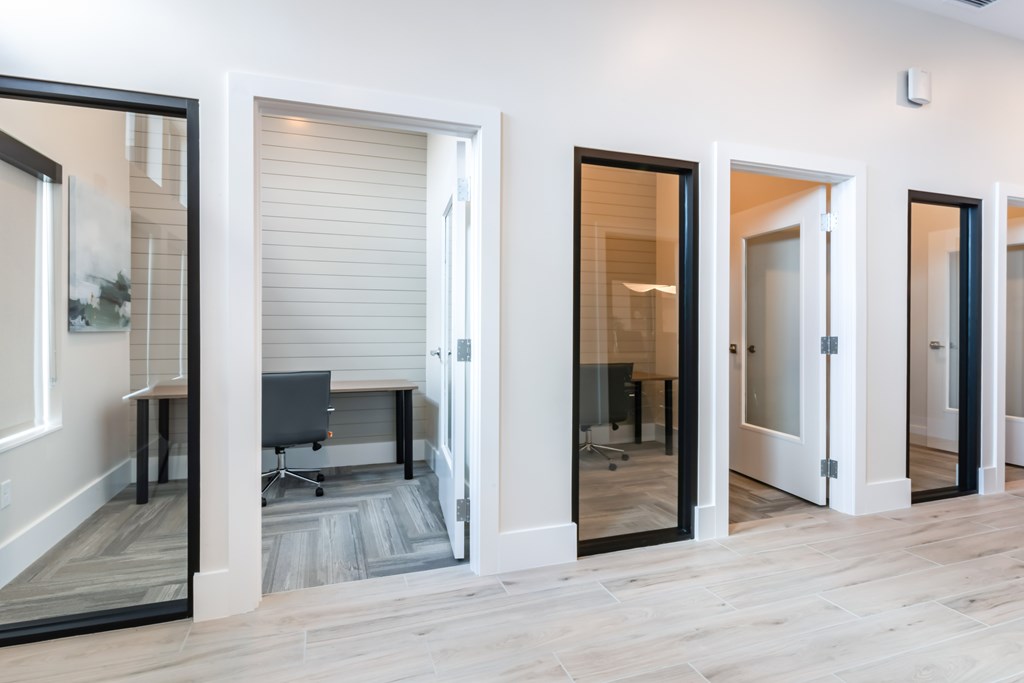 A room with a desk and chair in it.