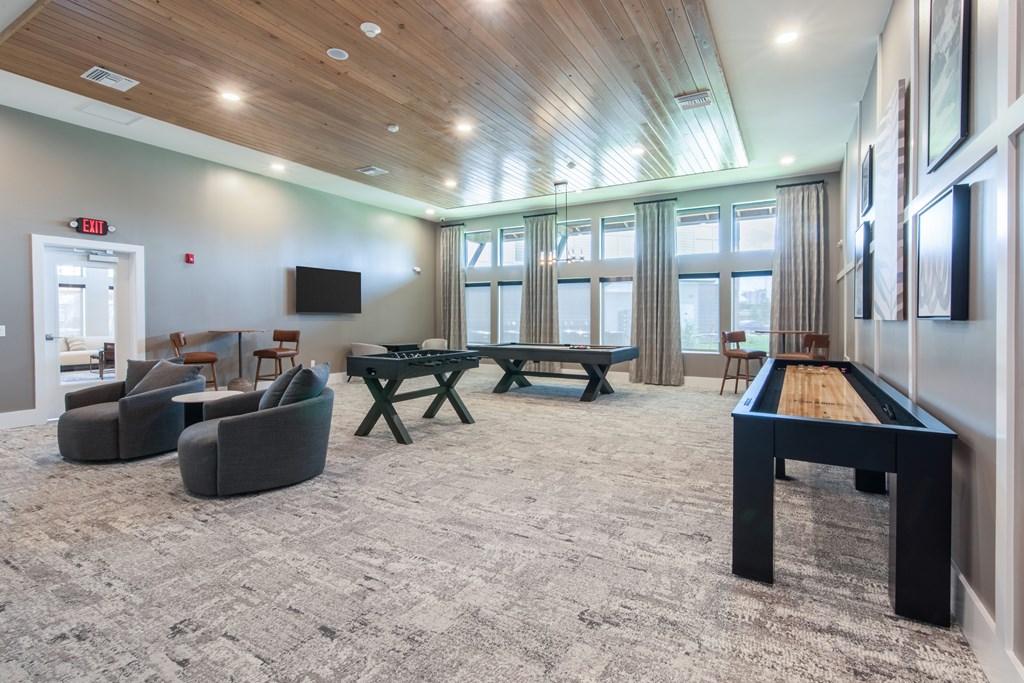 A room with a pool table and a television.