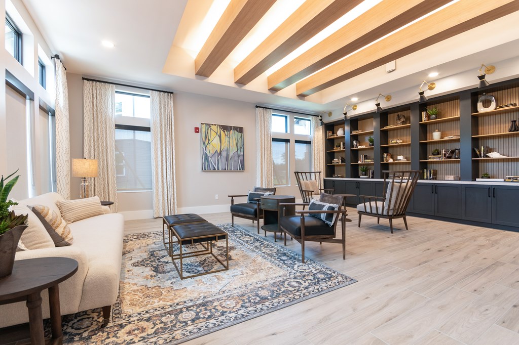 A living room with a white sofa, a coffee table, and a rug.