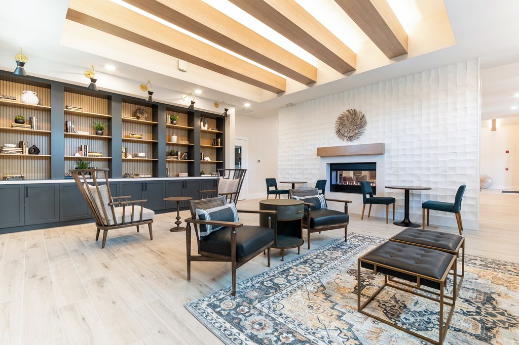 A living room with a fireplace and a large rug.