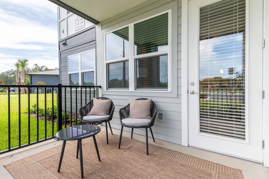 A patio with a table and two chairs.