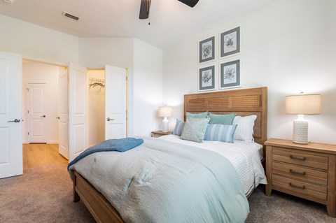 A bedroom with a bed, nightstand, and two lamps.