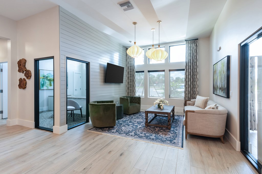 A living room with a wooden floor and a large window.