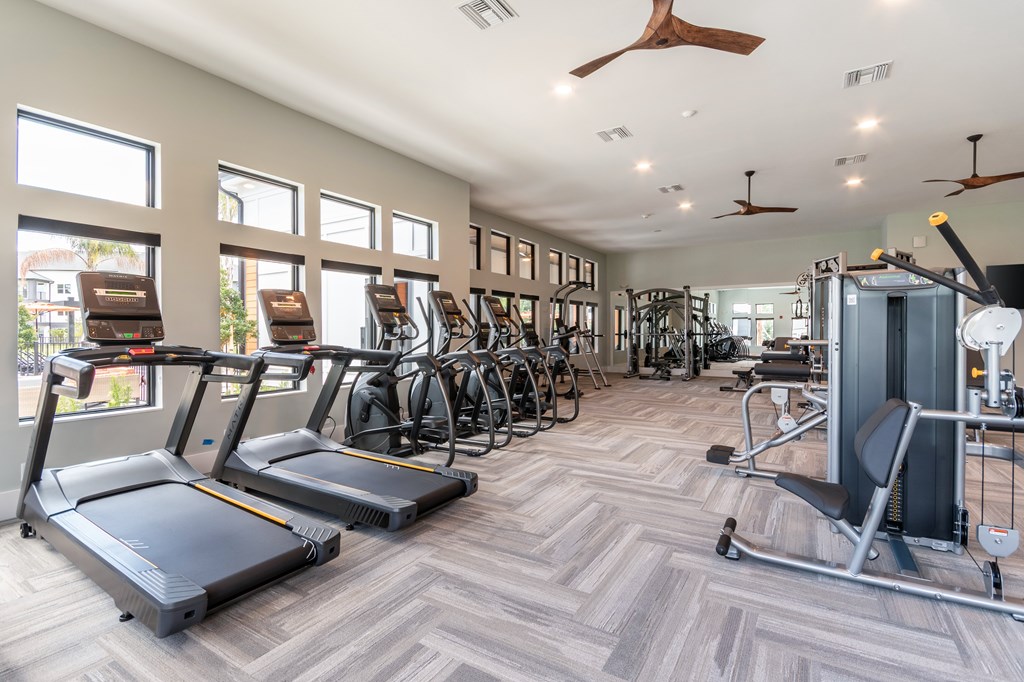 A gym with treadmills, exercise bikes, and other equipment at SW 38th Avenue Apartments in Ocala, FL.