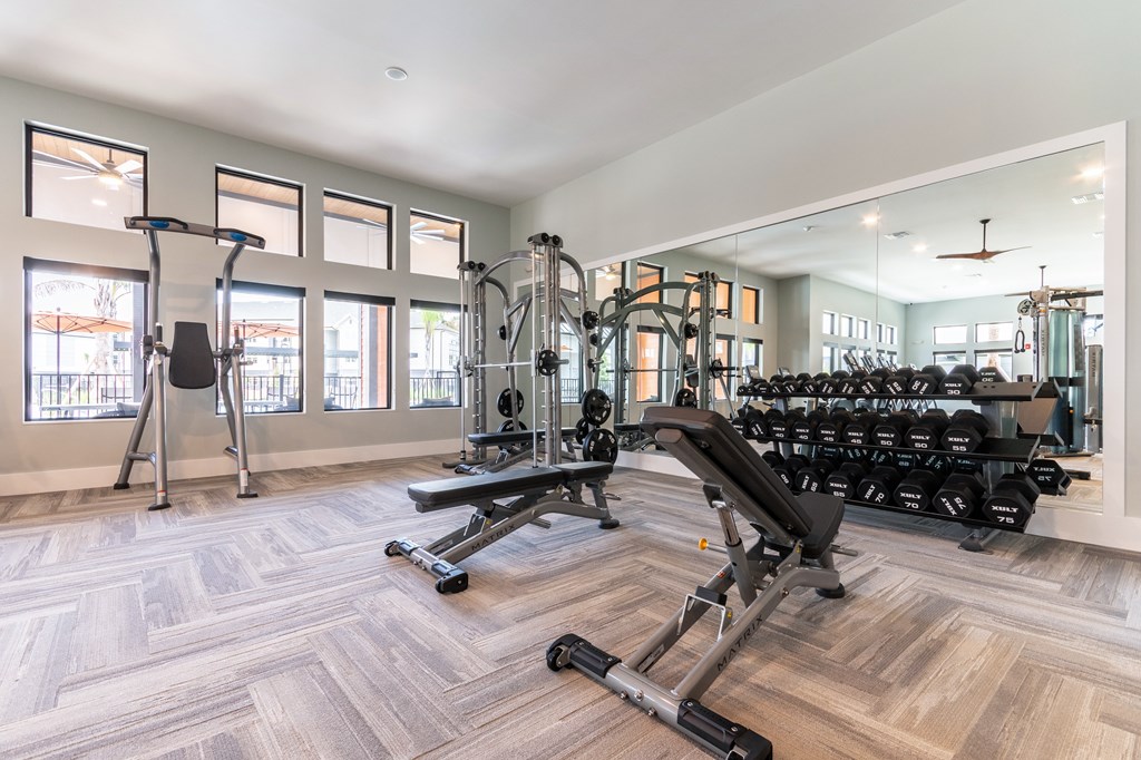 A spacious home gym with a variety of equipment.