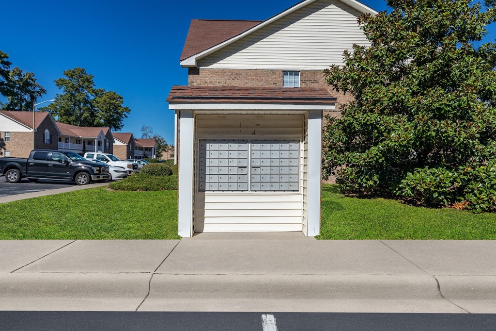 A small white garage with a calendar on the door.
