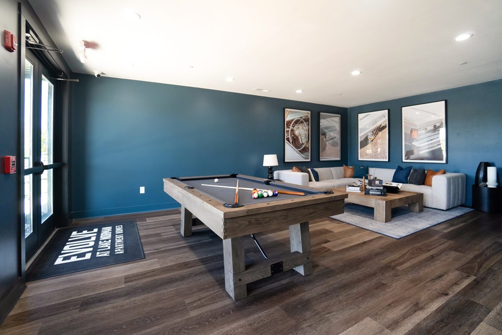 A room with a pool table and a couch at Evolve Lake Norman apartments in Mooresville, NC
