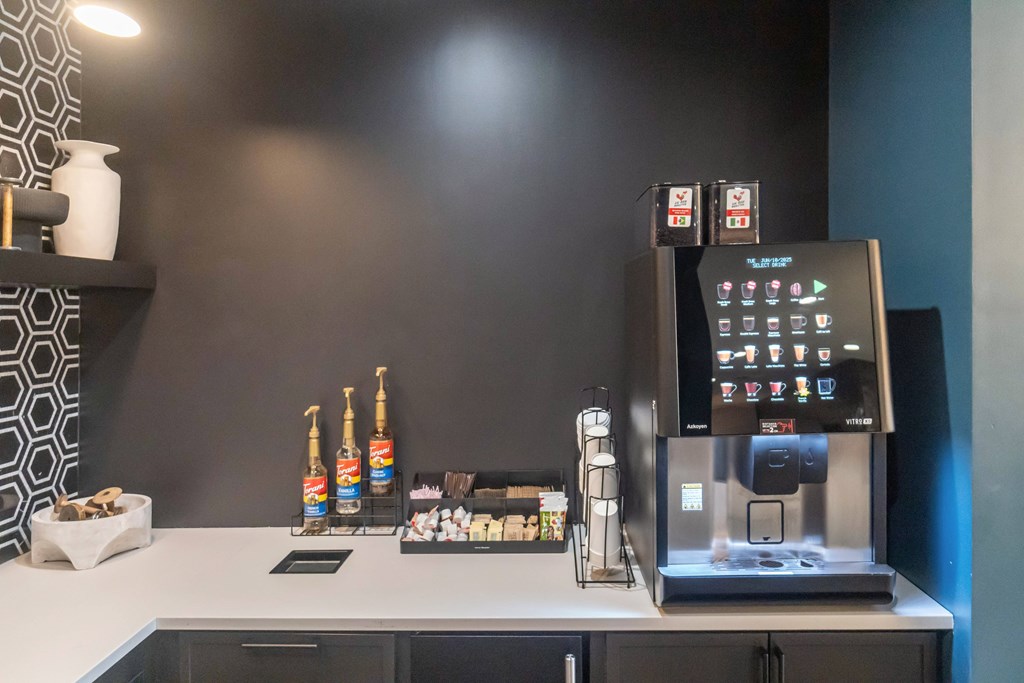 A coffee machine with a digital display and various coffee pods in front of it at Evolve Lake Norman apartments in Mooresville, NC