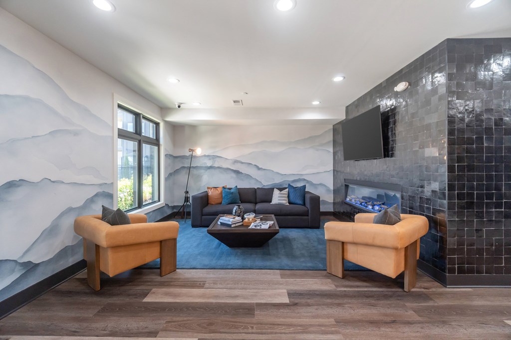 A modern clubhouse with a large mural of mountains on the wall at Evolve Lake Norman apartments in Mooresville, NC