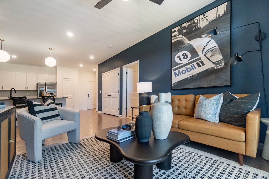A living room with a couch, chair, and coffee table at Evolve Lake Norman apartments in Mooresville, NC