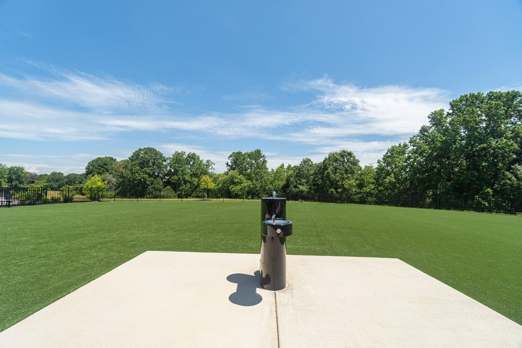 A concrete platform with a black cylindrical object on top at Evolve Lake Norman apartments in Mooresville, NC