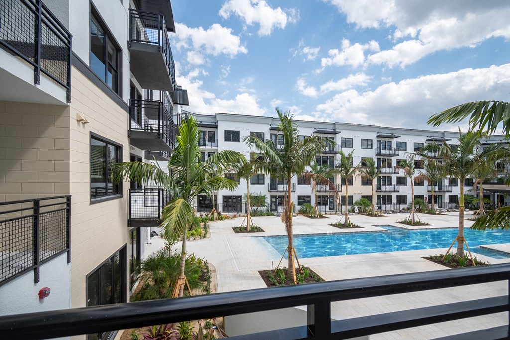 a view of the pool from a balcony of an apartment building