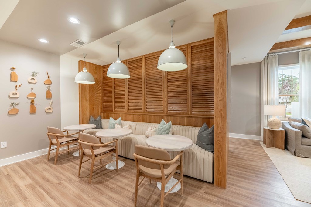 a dining room with tables and chairs and a couch