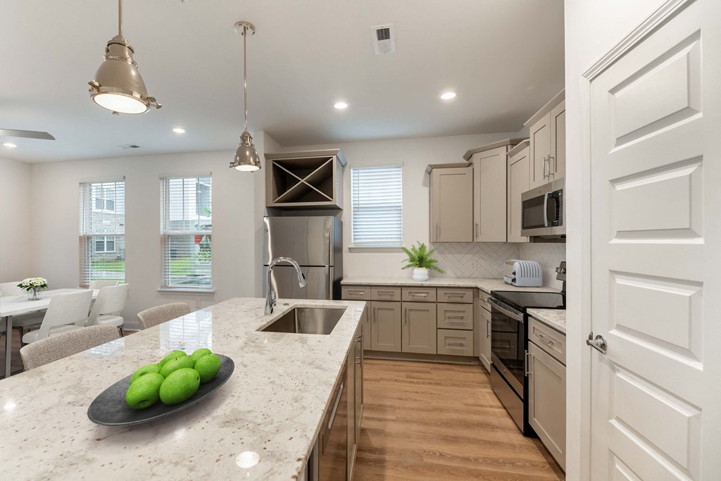 a kitchen with a marble counter top and a sink