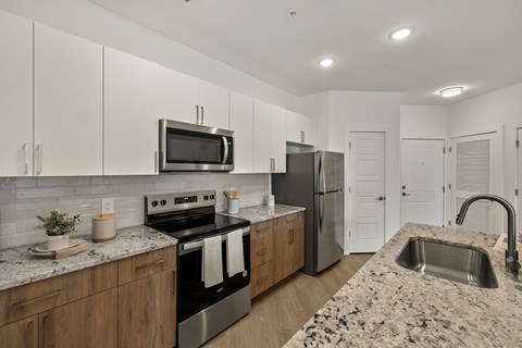 a modern kitchen with granite counter tops and stainless steel appliances
