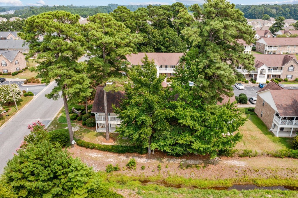 an aerial view of a neighborhood with houses and trees