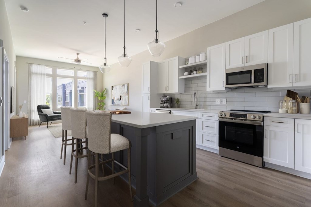 A kitchen with a bar area and a dining table.