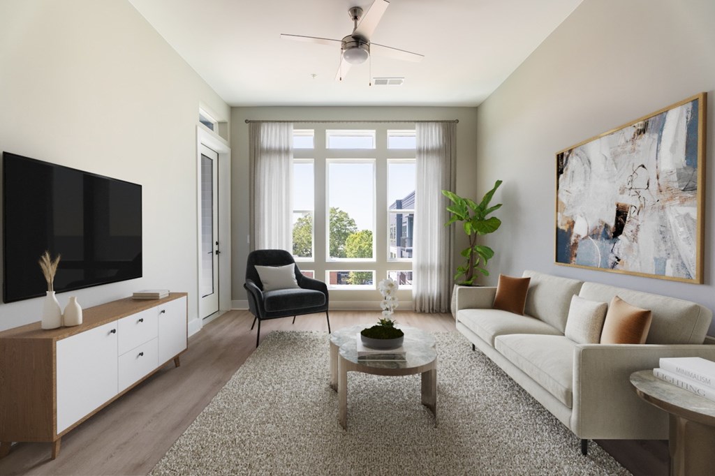 A living room with a black chair and a white couch.