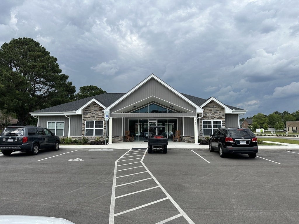 a parking lot with cars in front of a building
