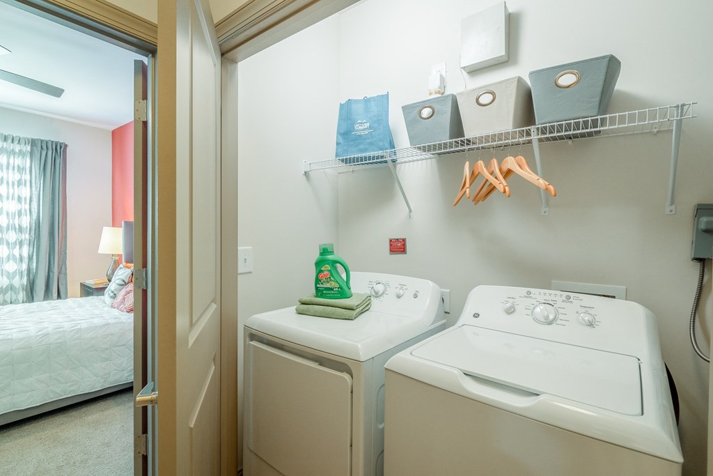 a laundry room with two washes and a dryer in it next to a