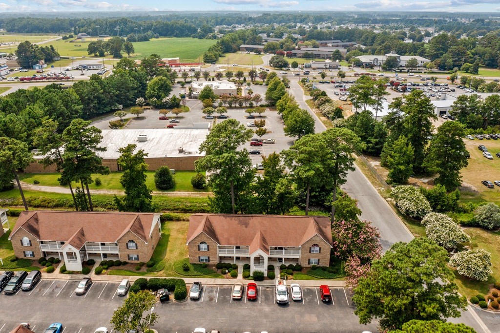an aerial view of a neighborhood with houses and parking lot