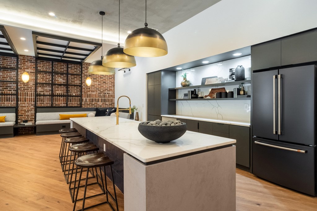 a kitchen with a large island with a bowl of rocks on it