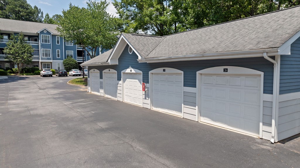 a row of garages in front of an apartment building