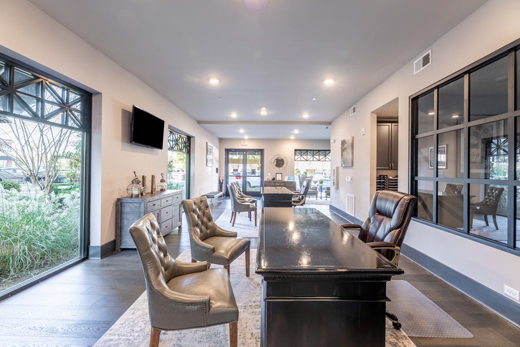 a large living room with a large table and chairs