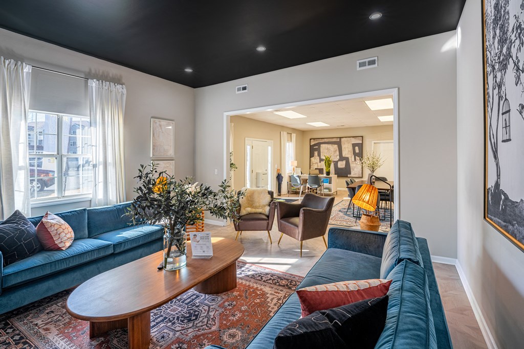 a living room with blue couches and a coffee table