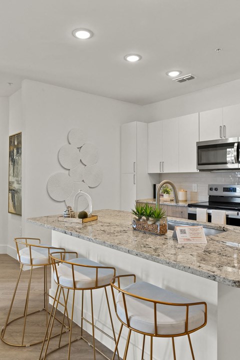 a kitchen with white cabinets and a counter top