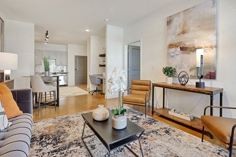 A modern living room with a grey sofa and a coffee table.