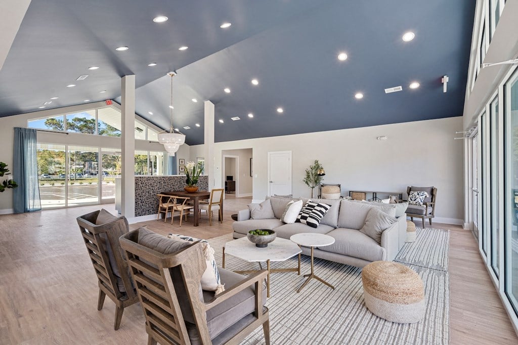 a living room with a couch and chairs and a table