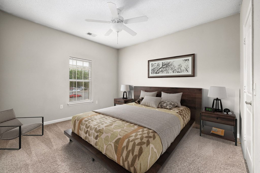 a bedroom with a bed and a ceiling fan