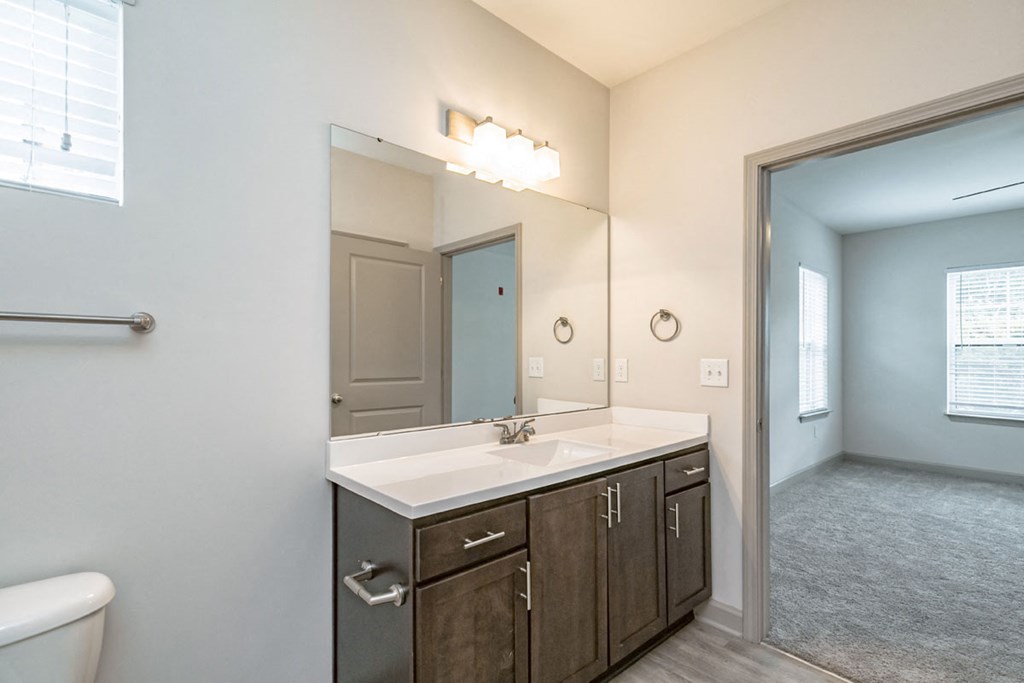 an empty bathroom with a large mirror and a sink