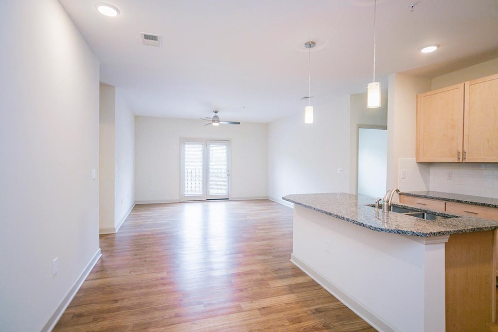 an empty kitchen and living room with a counter top