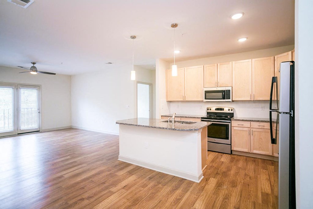 an empty kitchen with a counter top and
