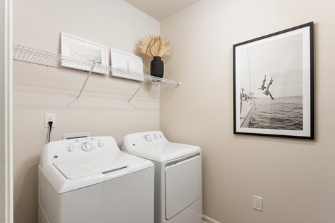 A laundry room with two washing machines at Evolve Holly Ridge Apartments in Holly Ridge, NC.
