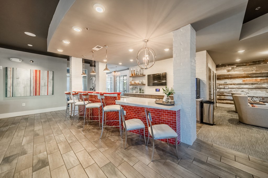 a kitchen with a bar and chairs in a house
