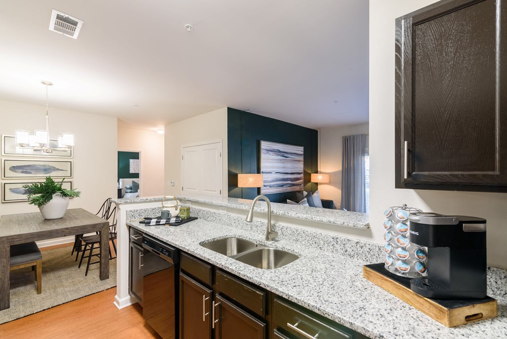 a kitchen with granite counter tops and a stainless steel sink