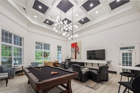 a living room with a pool table and a tv