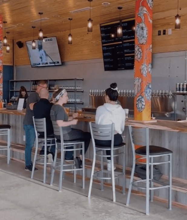 people sitting at a bar in a restaurant