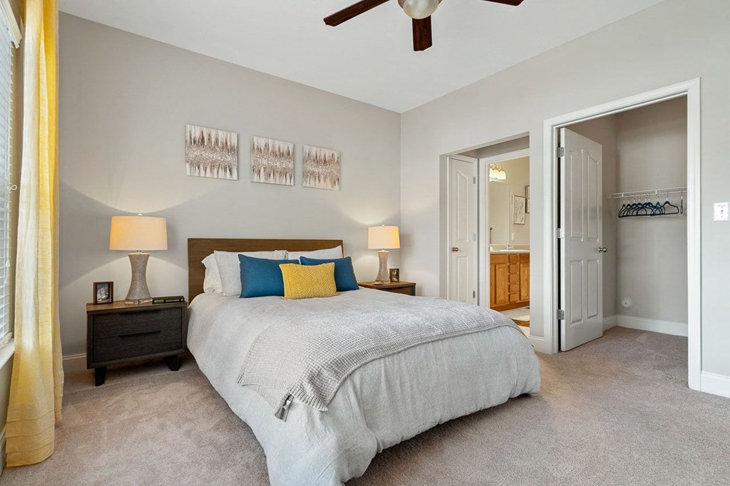 a bedroom with a bed and a ceiling fan