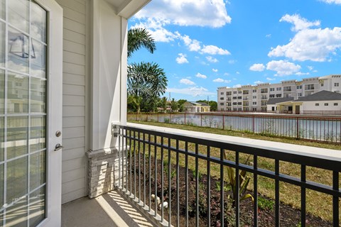 the view from the balcony of an apartment building overlooking the water