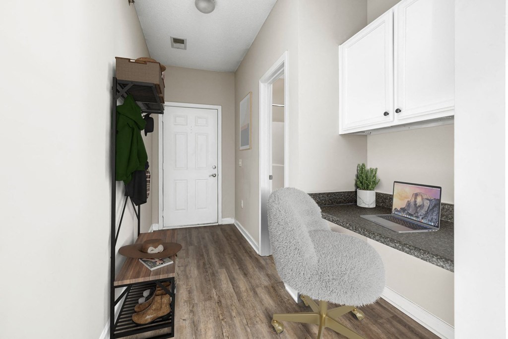 an office with a chair and a desk with a laptop