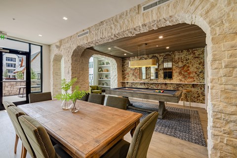 a dining room with a table and a pool table